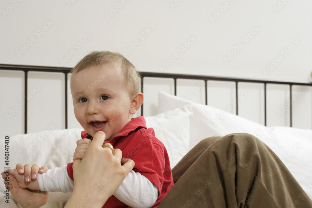 Mother and son sitting on a bed