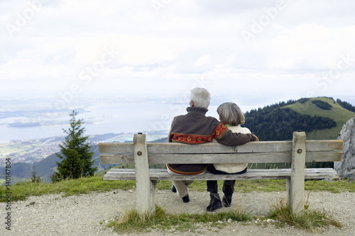 Senior adult couple sitting on a bench