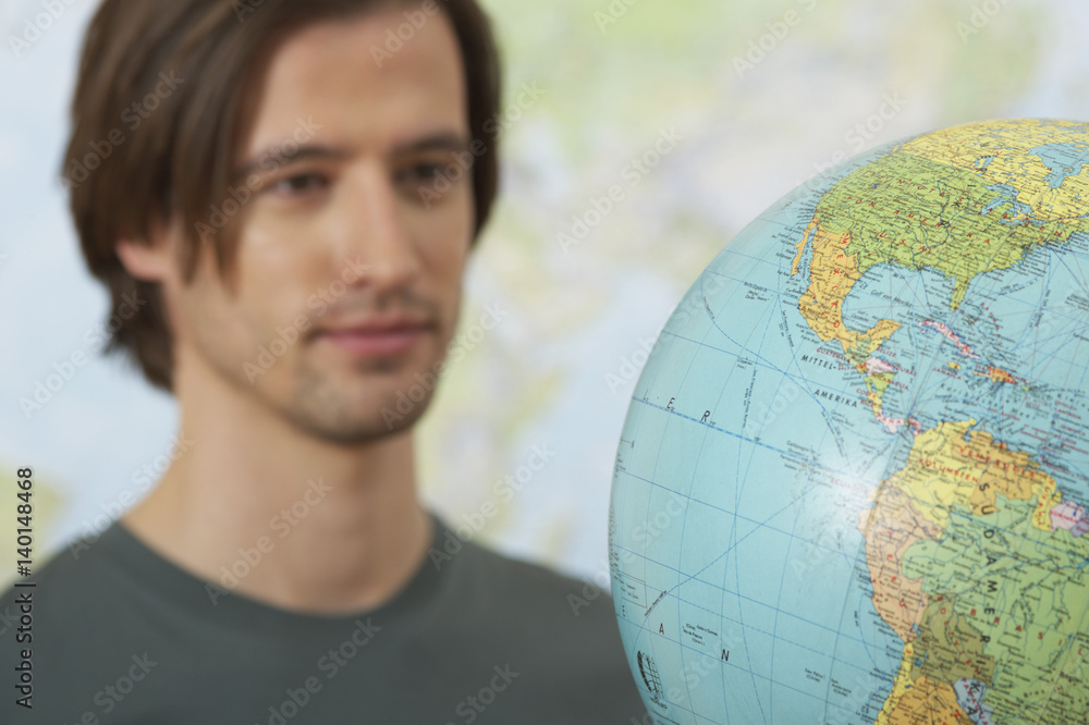 A Man beside a globe