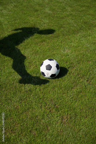 Shadow of a kicker playing a ball