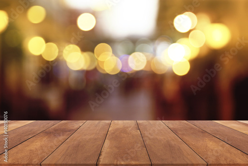 Wood table top with abstract blurred light bokeh background