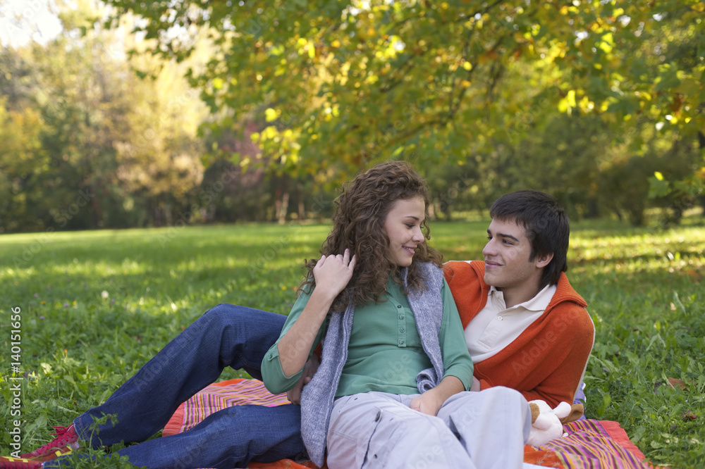Teenage boy and girl lying on a sheet together, high angle view Teenage boy and girl lying on a sheet together, high angle view