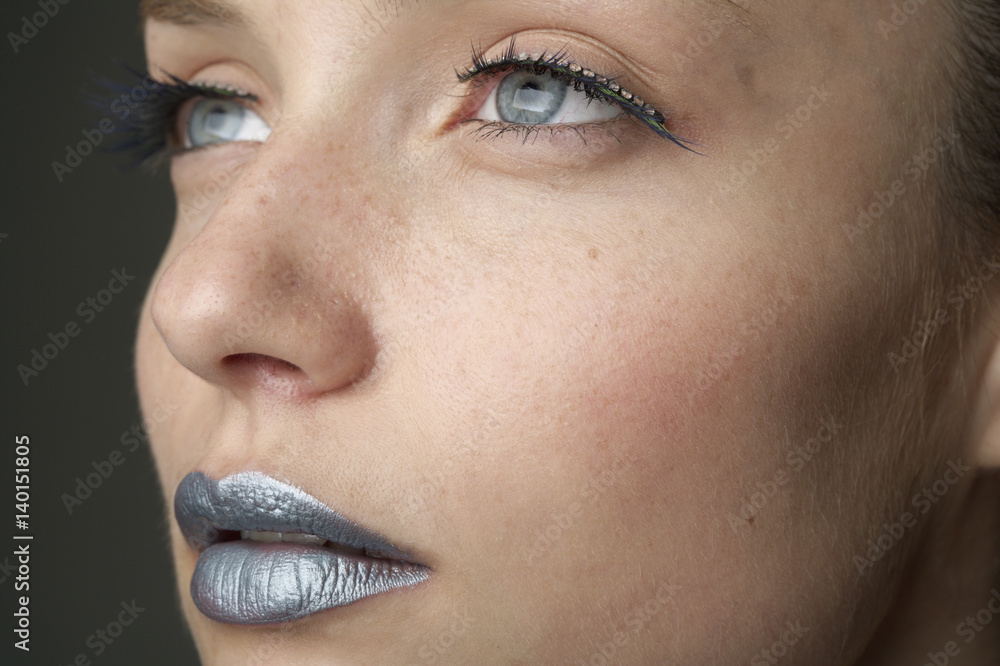 Naklejka premium Young woman with silver colored lips (part of), close-up