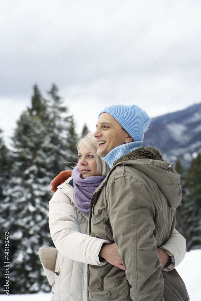 Couple wearing warm clothing embracing each other Couple wearing warm clothing embracing each other