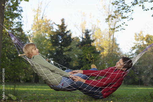 Teenage couple in a hammock, selective focus