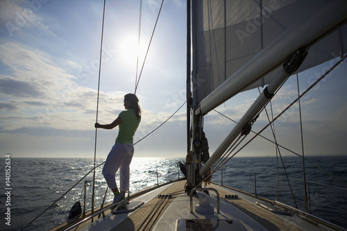 Woman standing on a sailing yacht