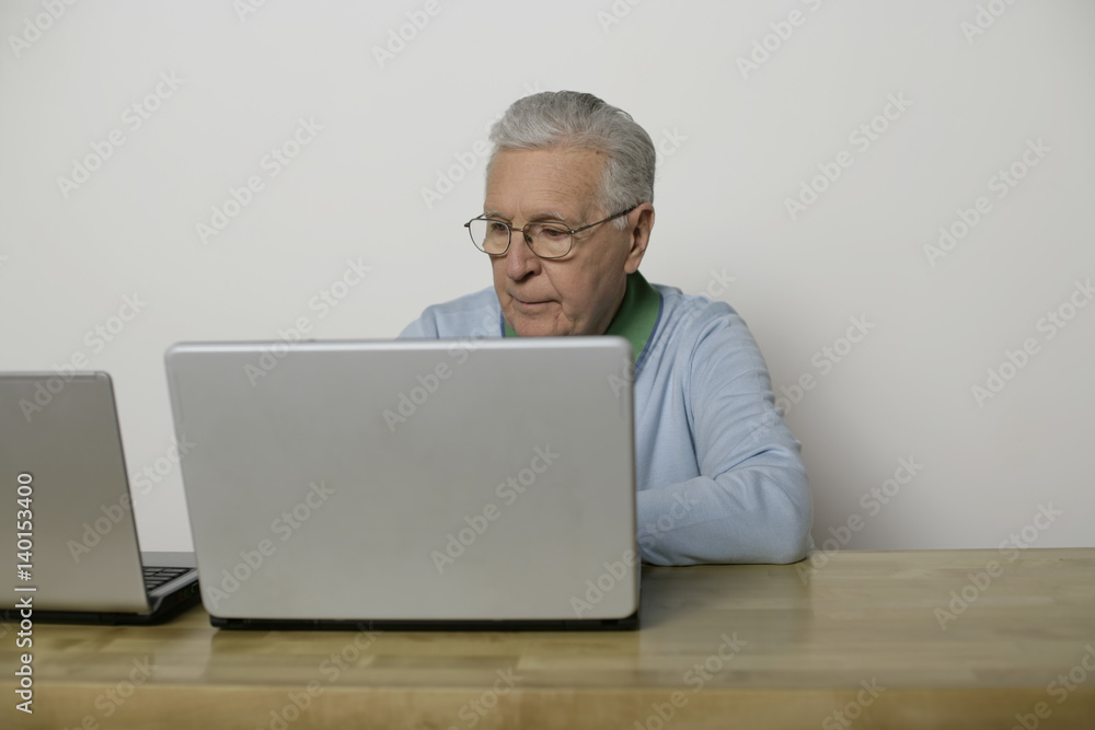Senior man using a laptop, fully_released