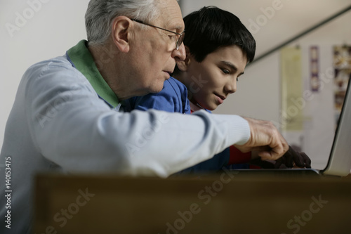 Grandfather and boy using a laptop, fully_released