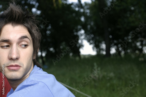Portrait of a who is looking over his shoulder