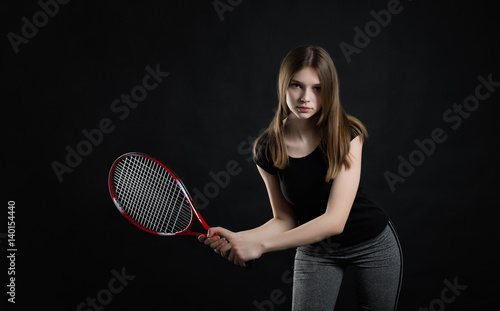 Portrait of sporty teen girl tennis player with racket © kulichok