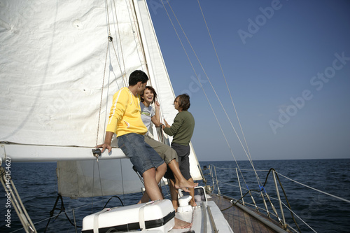 Two men and a woman on a sailboat