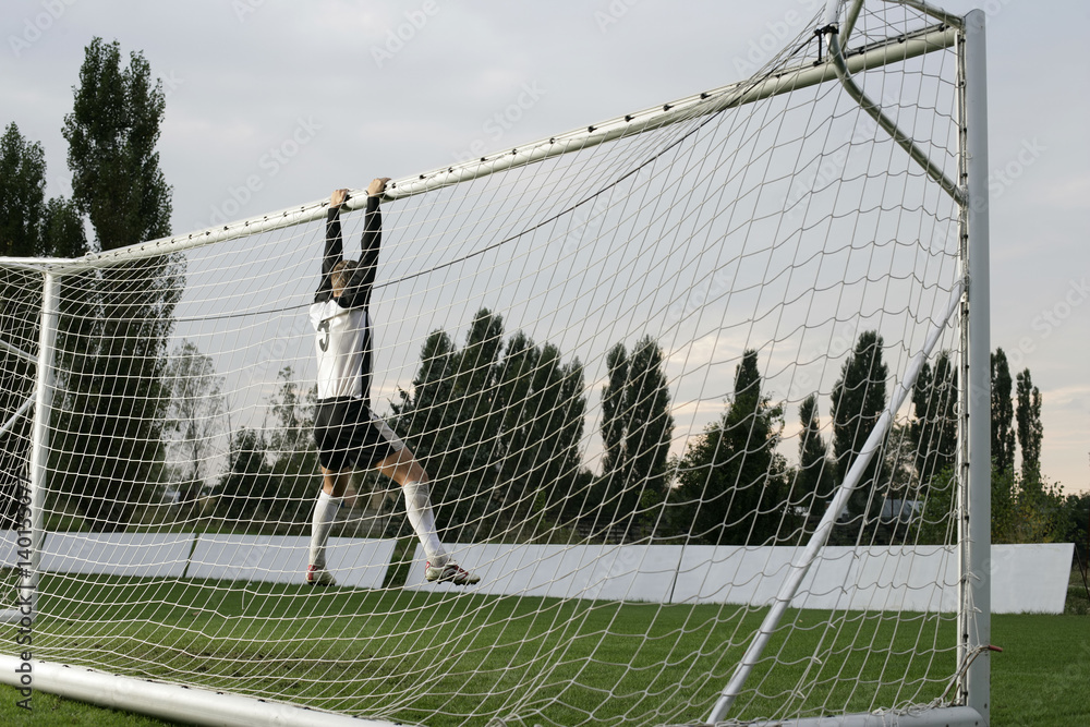 Goalkeeper hanging at the goal