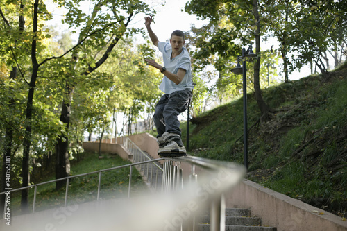 Boy inline skating over a balustrade