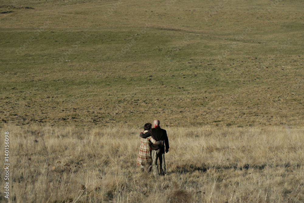 Man and woman standing on a field Man and woman standing on a field