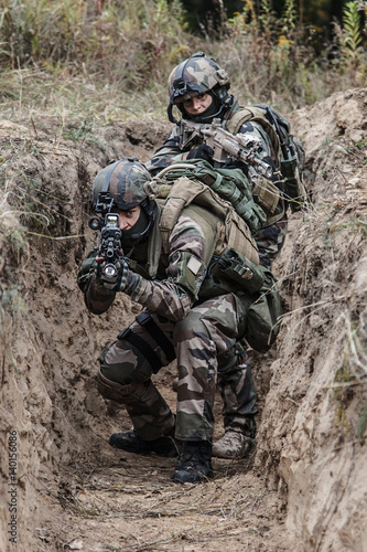 Paratroopers of french 1st Marine Infantry Parachute Regiment RPIMA in entrenchments, pointing to camera front view