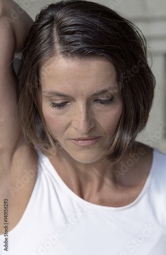 Dark-haired Woman stretching her Arm backwards - Stretching