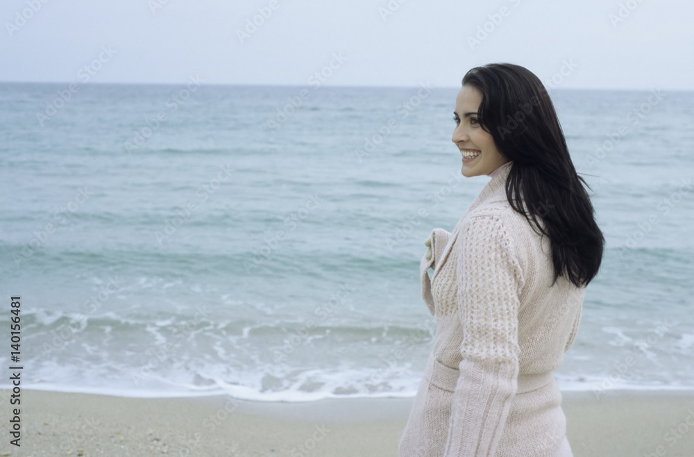 Young brownhaired Woman with Cardigan at the Beach - Season - Nature Young brownhaired Woman with Cardigan at the Beach - Season - Nature