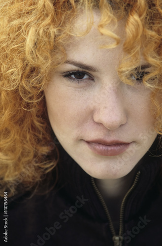 Portrait of a young Woman with strawberry-blonde Curls - Hair photo