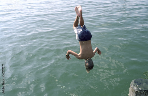Boy jumping headlong into Water - Swimming - Leisure Time - Youth