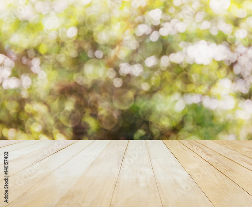 Blank or empty table top view on nature green bokeh tree background in summer sunlight