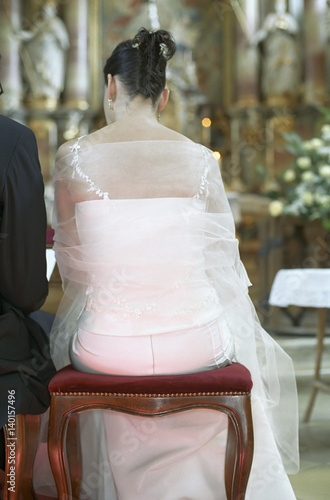 Bridegroom and Bride sitting in front of the Altar - Church - Wedding - Tradition - Christianity photo