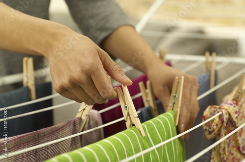 Woman hanging washing on clothes horse