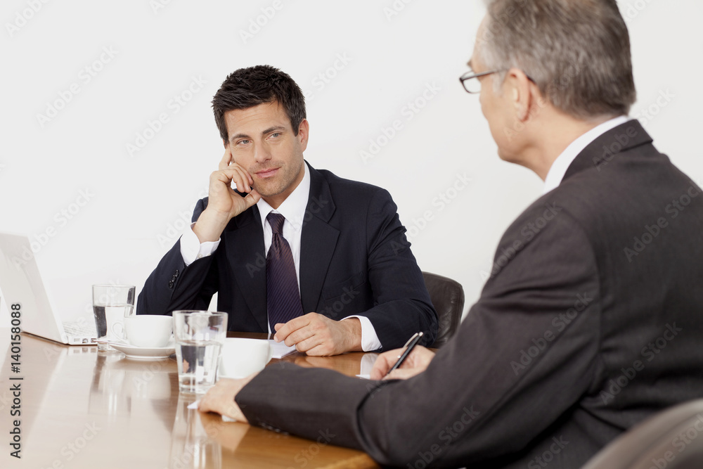 Two businessmen talking in conference room, Munich, Bavaria, Germany