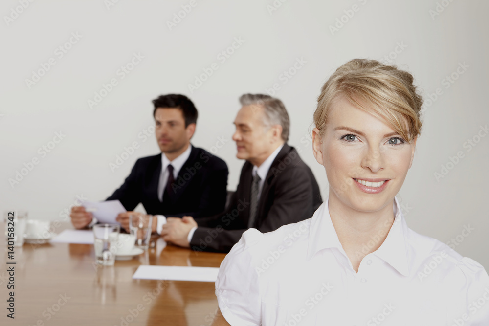 Three businesspeople in conference room, Bavaria, Germany Three businesspeople in conference room, Bavaria, Germany