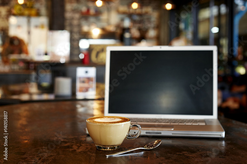 laptop with fresh cup of coffee