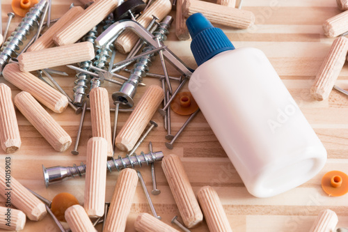 Photos Group of connecting material on wooden background (screws, nails, Dowels, plugs,