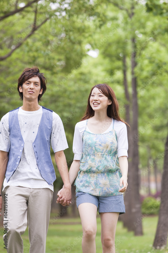 Young couple walking holding hands Young couple walking holding hands