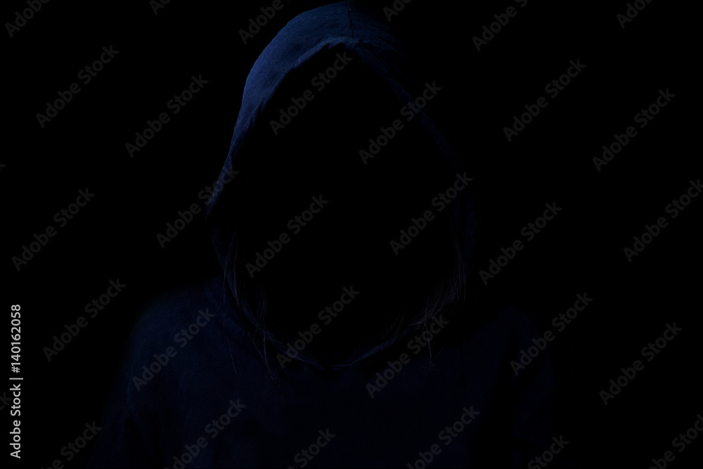 Mysterious, Low light image of Hacker. Unrecognizable person in the hood.