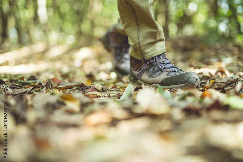 Shoes Man walking on a forest path in autumn and Lifestyle hiking concept. Shoes Man walking on a forest path in autumn and Lifestyle hiking concept.