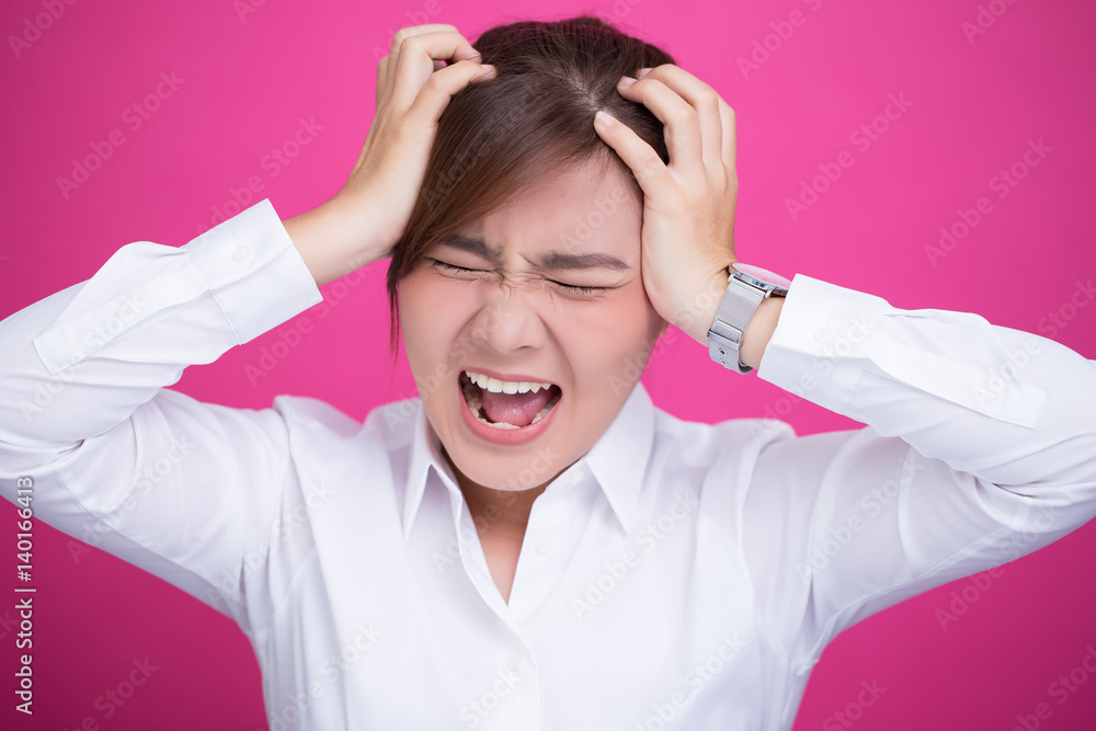 Angry woman screaming out and pulling her hair Angry woman screaming out and pulling her hair