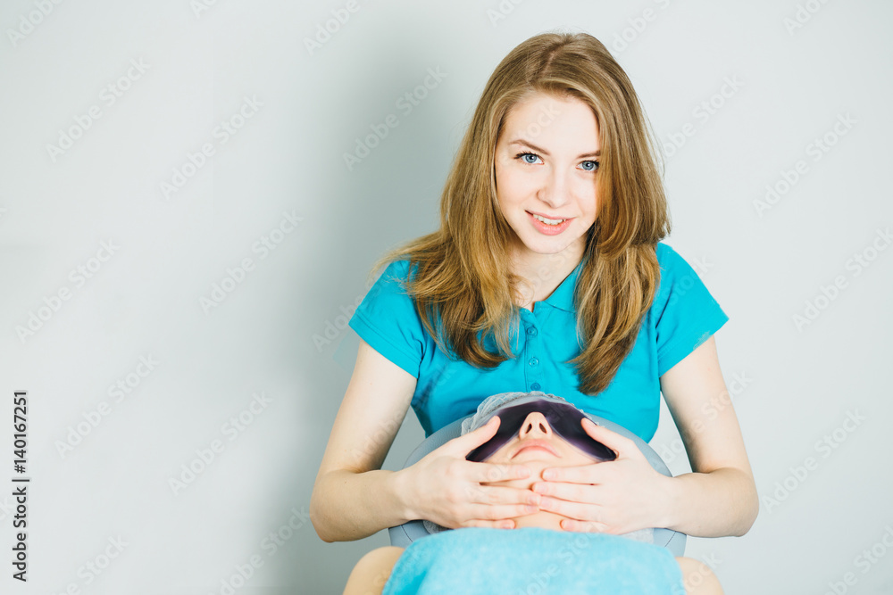 Portrait of beautician doing facial massage Portrait of beautician doing facial massage