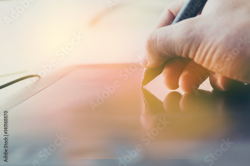 Concept of a digital signature on a tablet in the modern world. photo