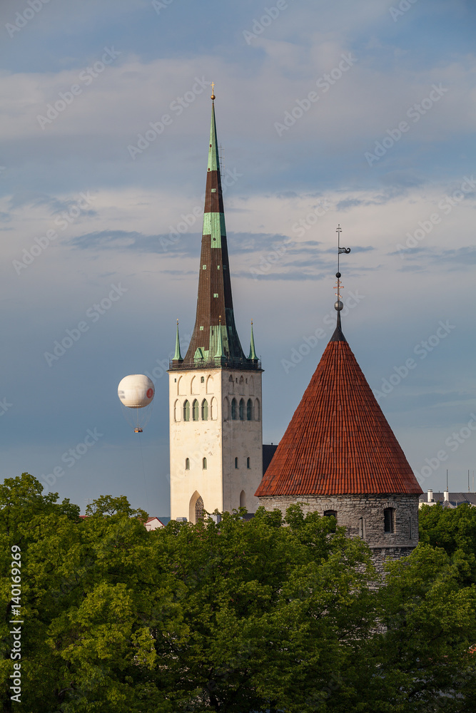 Medieval towers an church in old town of Tallinn. Summer green season.