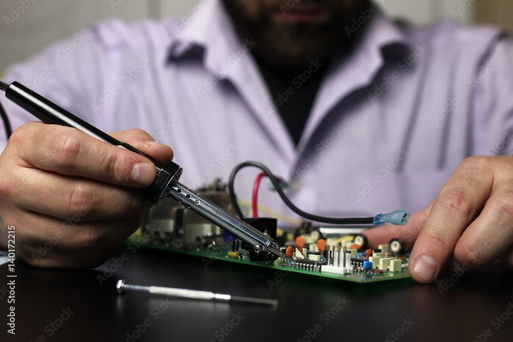 chip soldering man hands chip soldering man hands