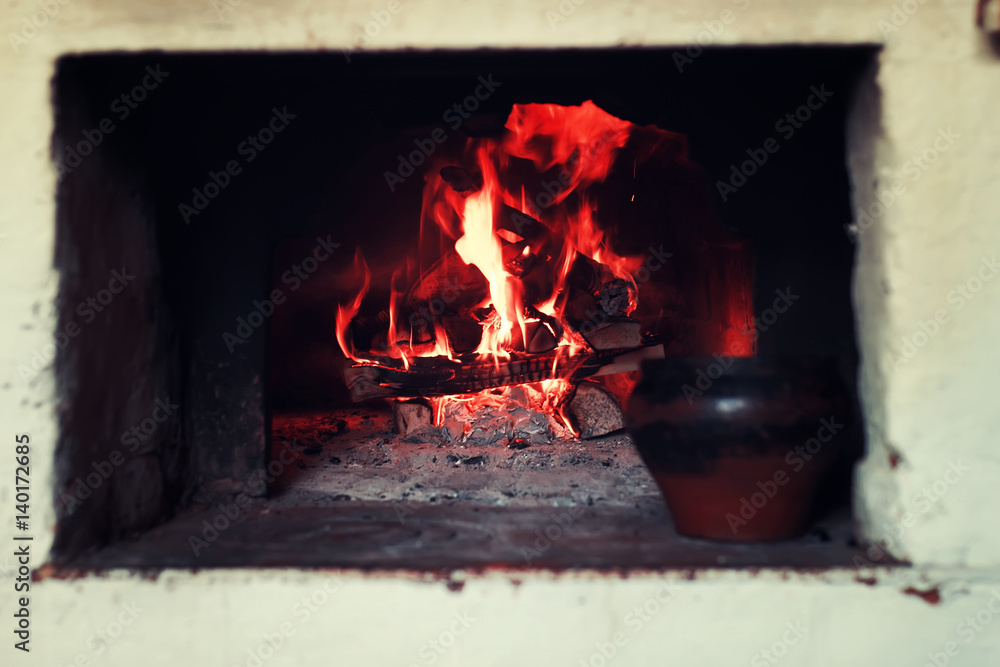 Obraz premium pot in the oven and oven fork