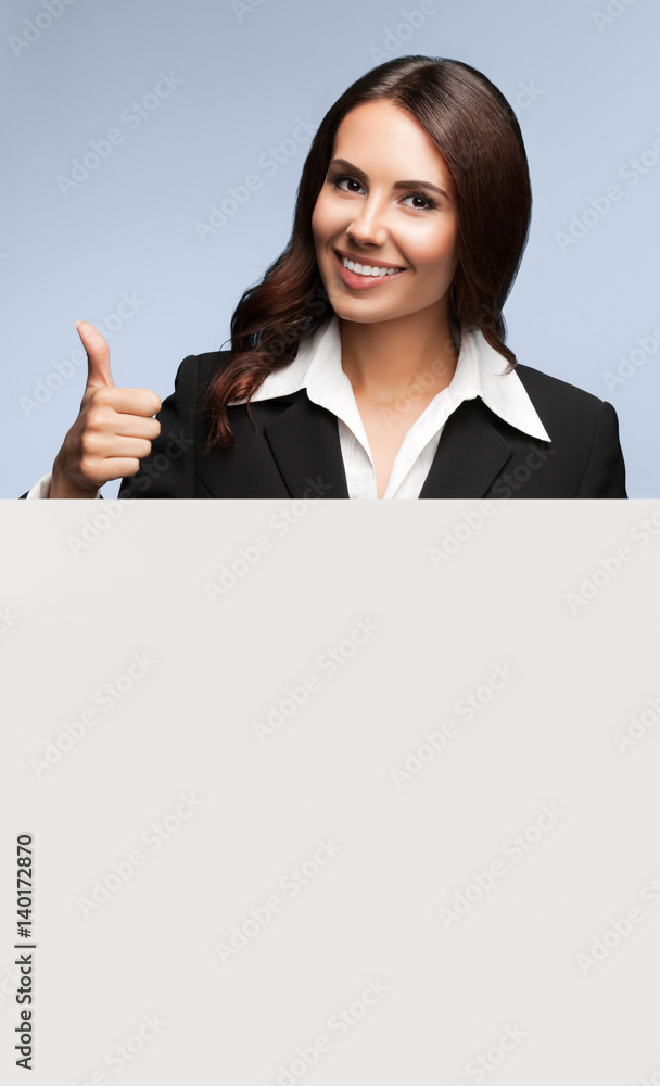 businesswoman showing blank signboard on grey businesswoman showing blank signboard on grey