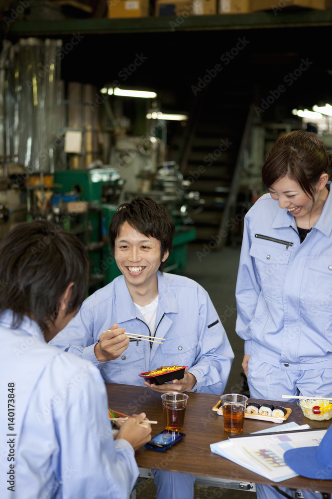 Three Factory Workers Having Lunch Break Three Factory Workers Having Lunch Break