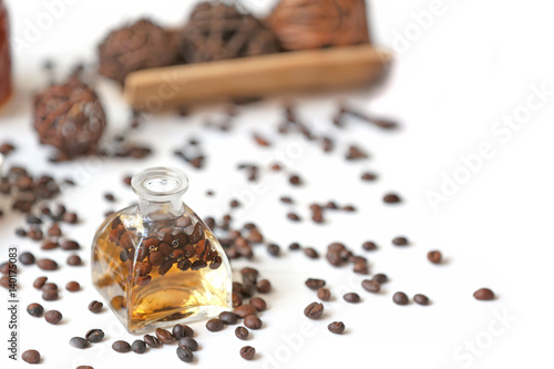 Spa concept. Aroma oil and coffee beans on white background