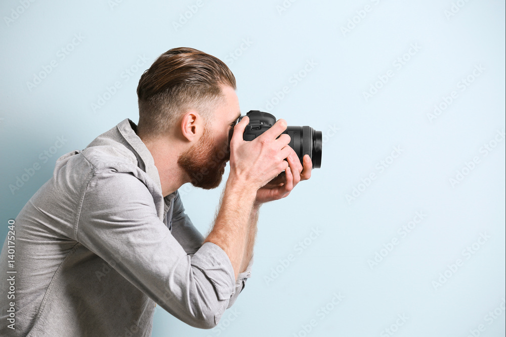 Handsome photographer on color background Handsome photographer on color background