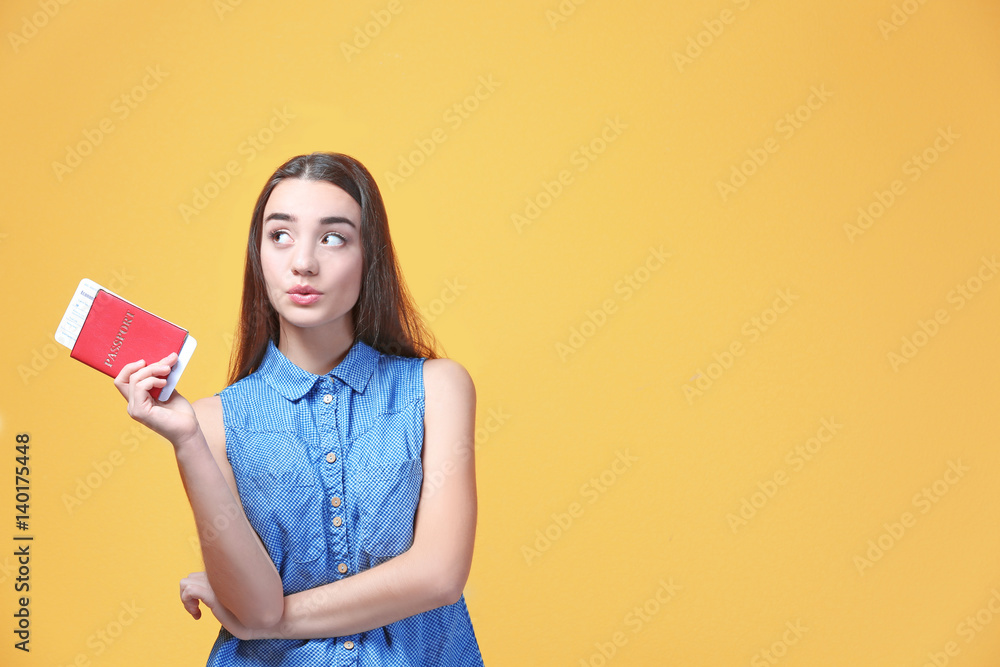 Beautiful young tourist with documents on color background Beautiful young tourist with documents on color background