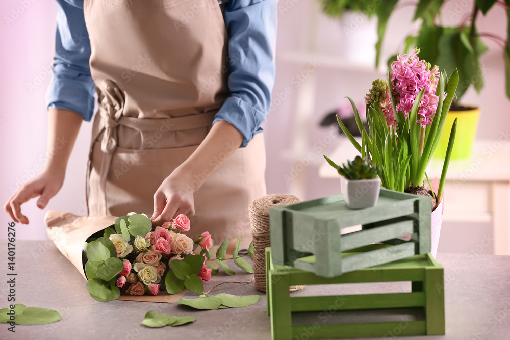 Fototapeta premium Female florist making beautiful bouquet