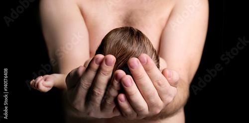Father with cute sleeping b...