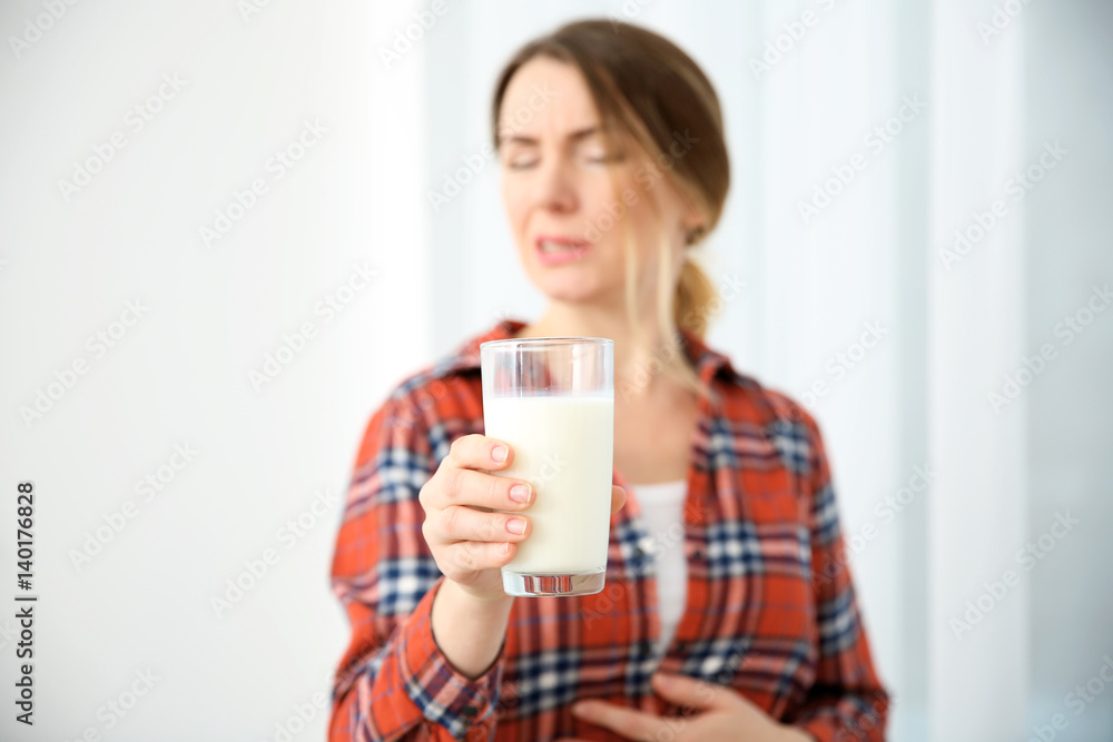 Young woman with milk allergy holding glass in hand Young woman with milk allergy holding glass in hand