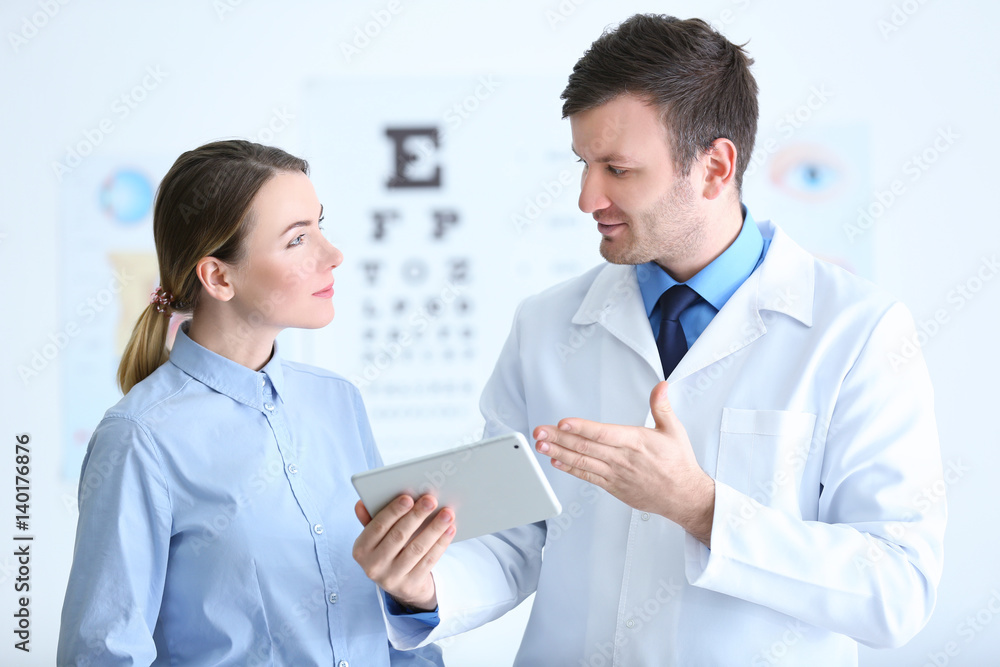 Woman visiting male ophthalmologist in clinic Woman visiting male ophthalmologist in clinic