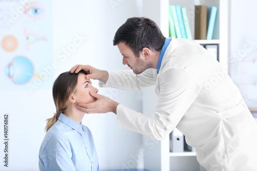 Adult male doctor examining patient