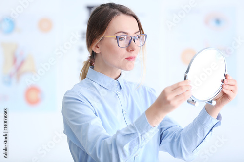 Woman trying on glasses at ...